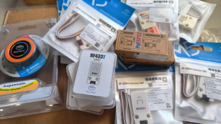 A collection of IoT sensors and controllers haphazardly strewn across a box