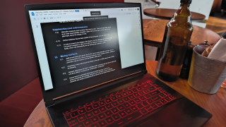 Laptop at a bar table with SOPs on-screen